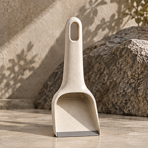 Front view of the STONE speckled cream dustpan and integrated handle