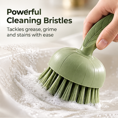 NATURA round green scrubber with leaf-shaped handle against a green background without text