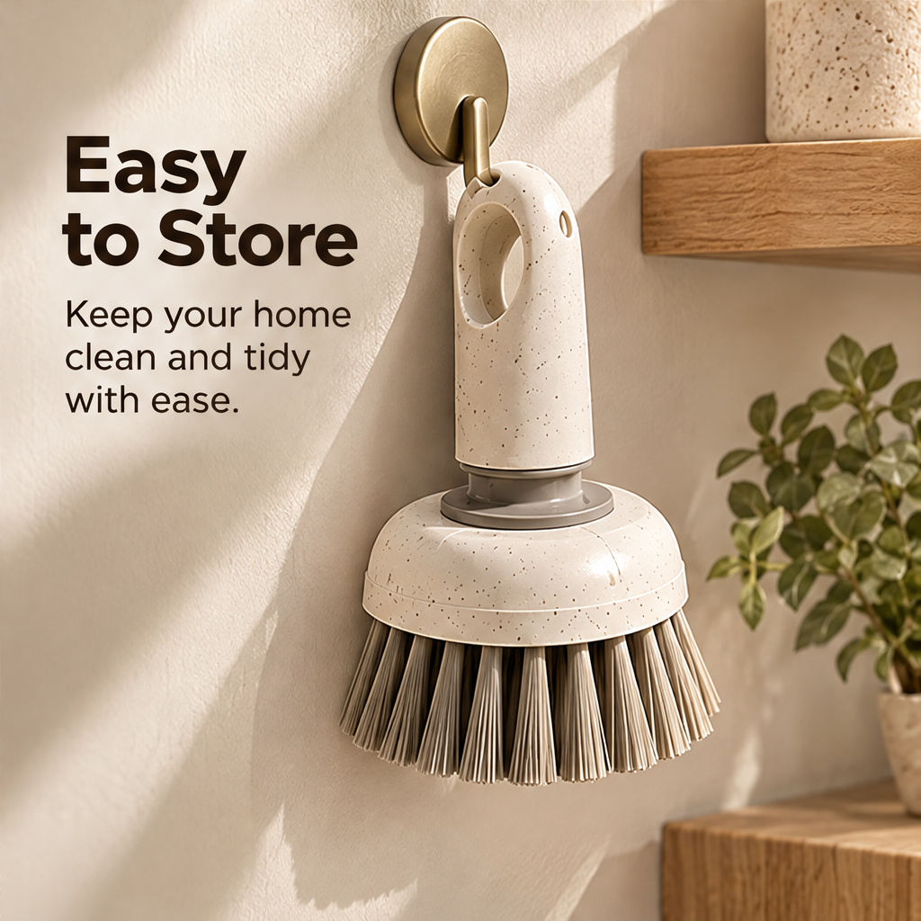 Hand using the STONE short-handled brush to scrub a wet sink surface